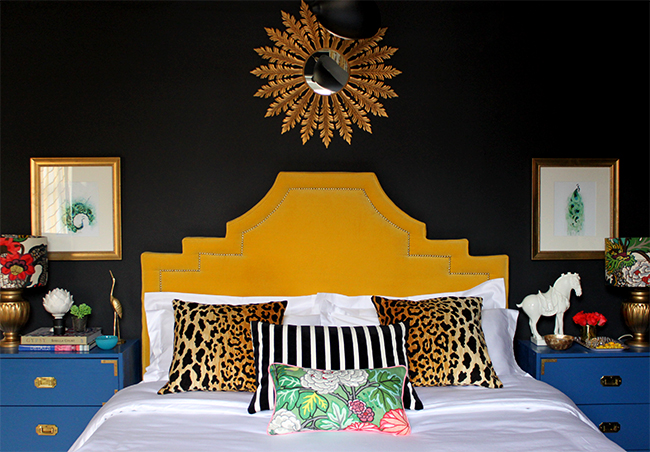 black bedroom with yellow headboard