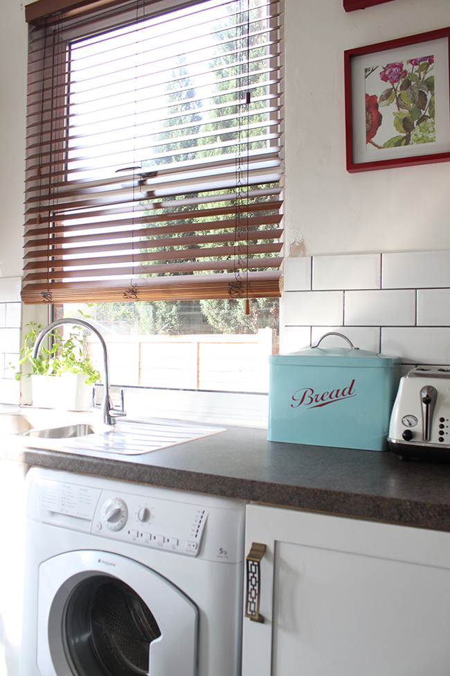 white kitchen with wood blind