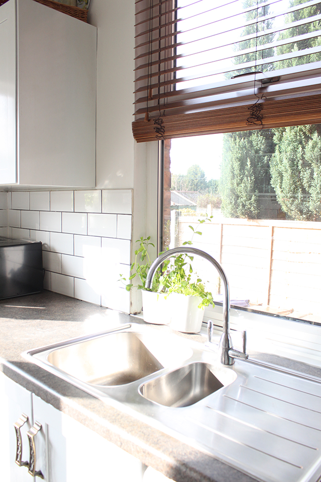 white kitchen with wood blind