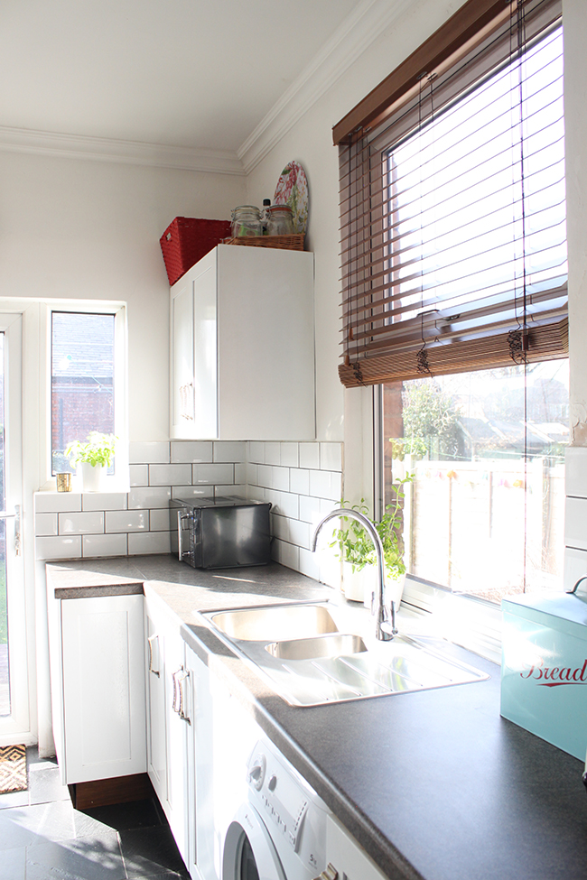 white kitchen with wood blind