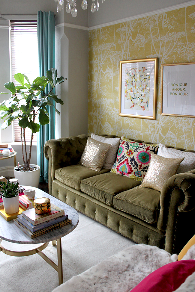 living room with olive chesterfield and gold accessories