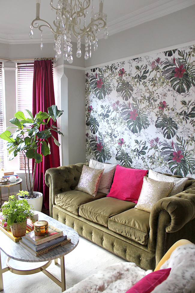 Swoon Worthy living room with Sian Zeng Summer Tropical Blossom wallpaper in olive and berry pink