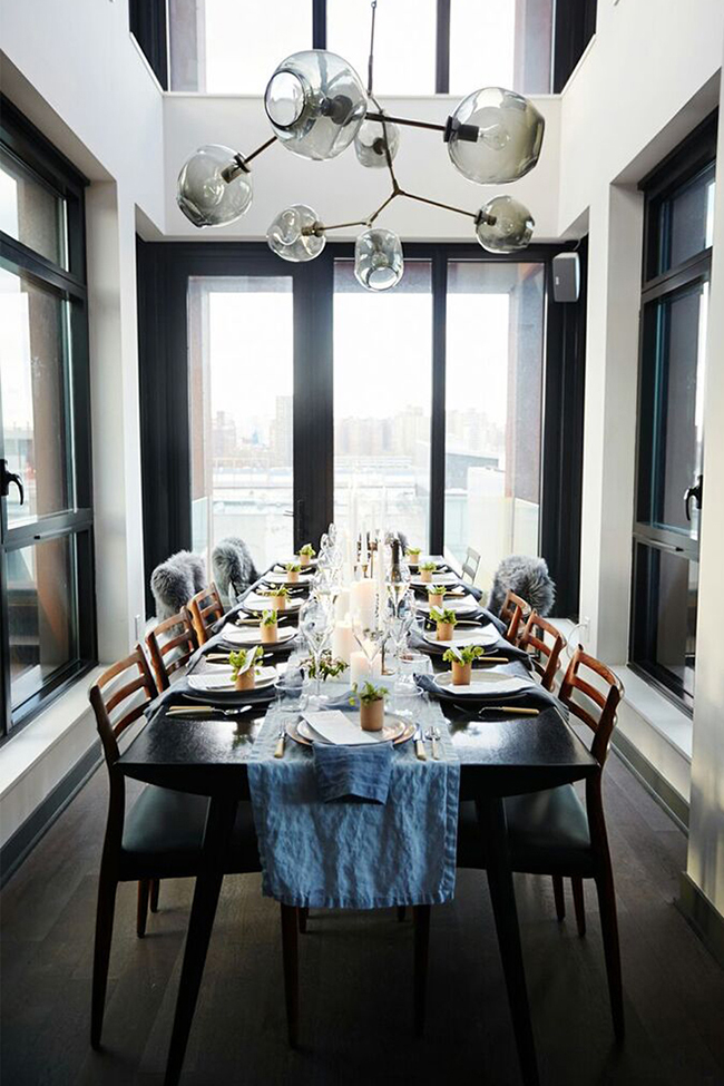 dining room with black frames and sexy light fixture