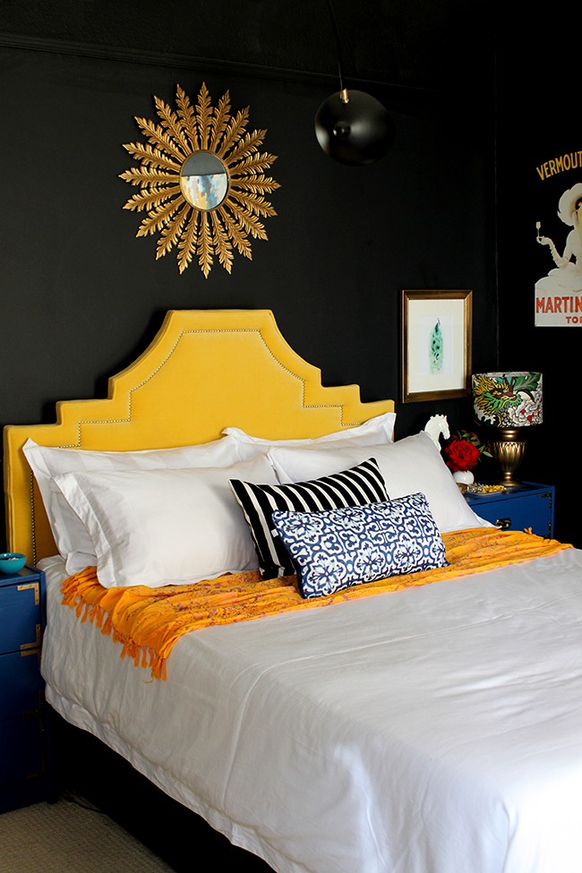 Swoon Worthy black bedroom with yellow velvet headboard