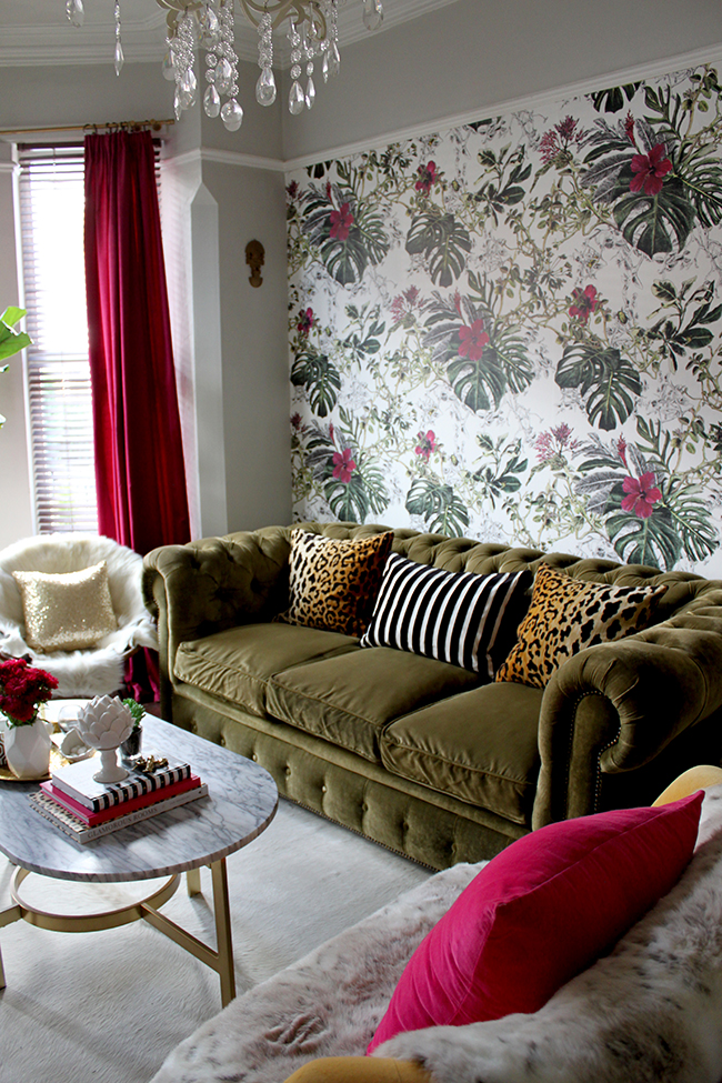 Swoon Worthy Living Room - tropical wallpaper, olive green velvet chesterfield with leopard cushions and marble coffee table