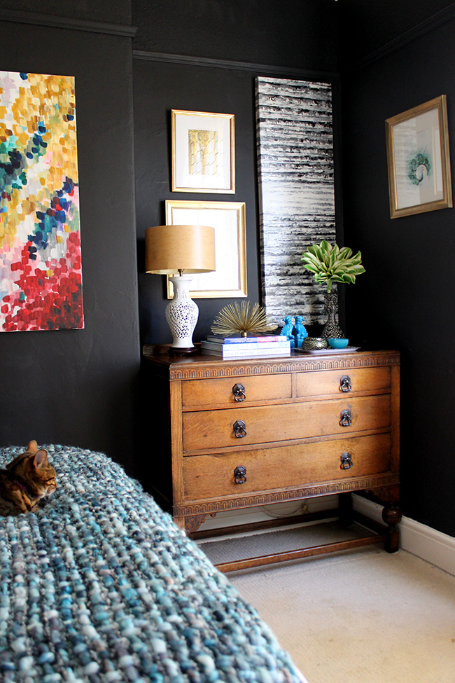 Swoon Worthy bedroom - vintage chest of drawers, black walls, colourful art