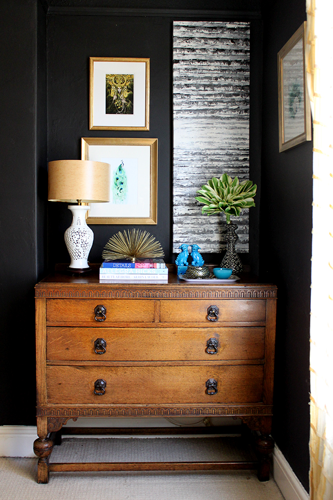 Swoon Worthy bedroom - vintage dresser, black walls, colourful art