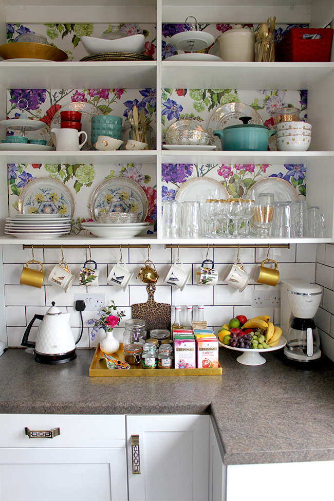 Swoon Worthy kitchen - floral wallpaper backed shelving, gold accents, leopard print cutting board