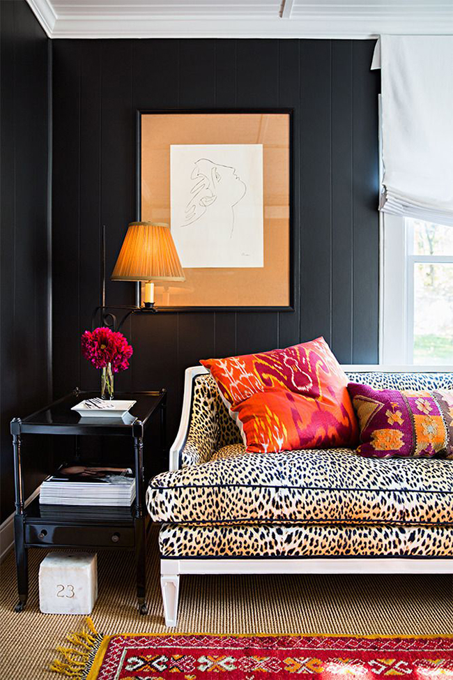 black living room with leopard print sofa