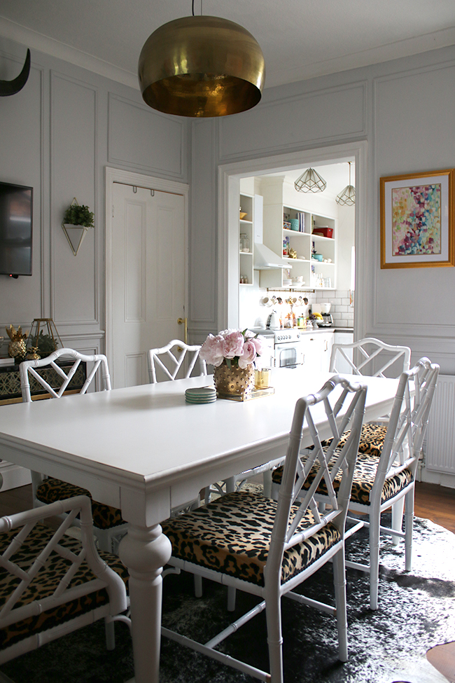 grey dining room with panels and leopard print chairs