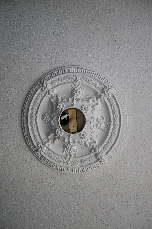 ornate ceiling rose with missing light