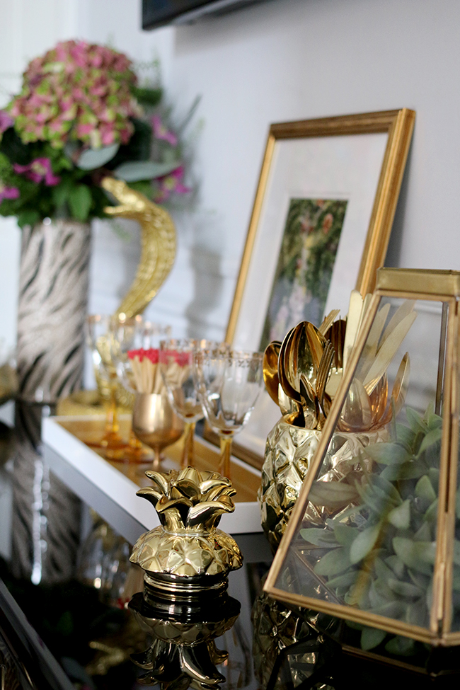 console table vignette with lots of gold - see more on www.swoonworthy.org