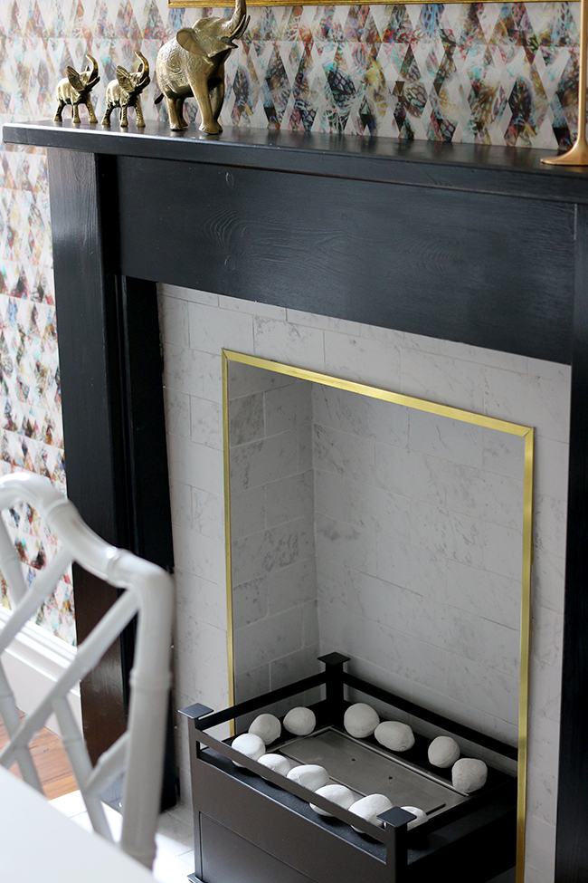 black fireplace with white marble and gold trim - see more on www.swoonworthy.org