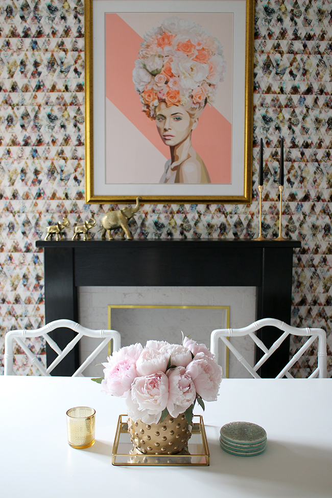 graphic feature wallpaper on chimney breast, black and white marble fireplace with gold trim, peonies - see more on www.swoonworthy.org