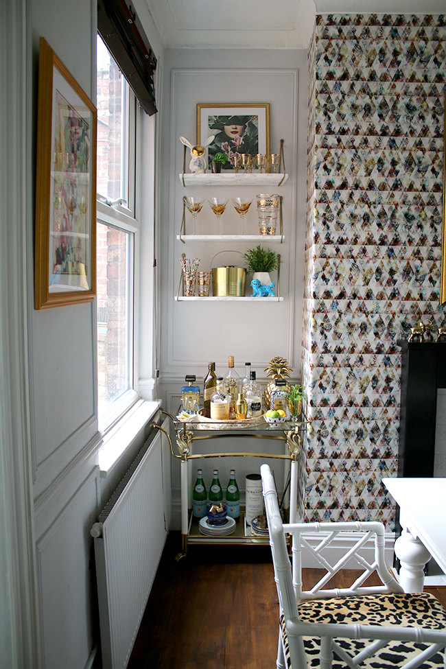 bar cart with marble effect shelves and graphic wallpaper - see more on www.swoonworthy.org