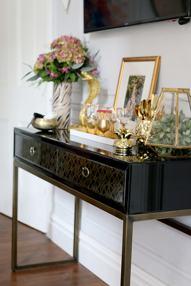 console table vignette with lots of gold - see more on www.swoonworthy.org