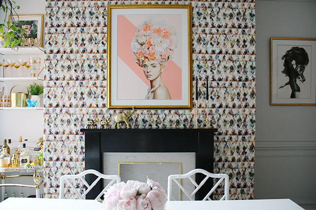 graphic feature wallpaper on chimney breast, black and white marble fireplace with gold trim, peonies - see more on www.swoonworthy.org