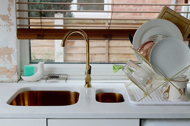 gold undermount sinks and tap with white cararra acrylic worktops