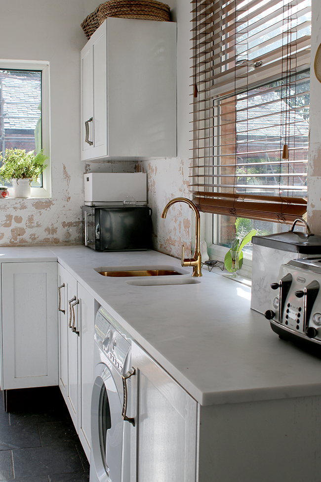 White Minerva Cararra Acrylic worktops with gold sinks and tap