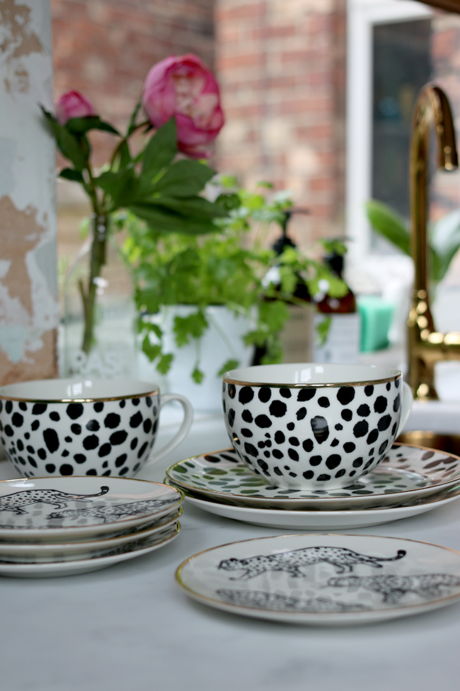 black and white leopard print mugs and plates with gold trim from H&M Home