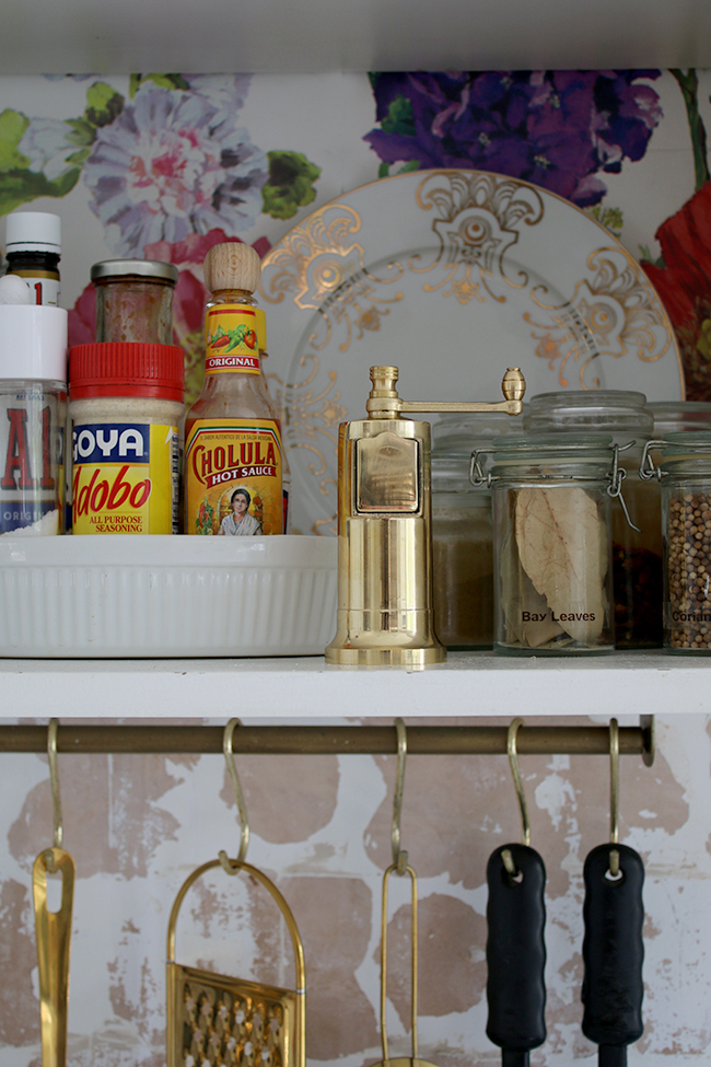 open shelving with gold pepper grinder