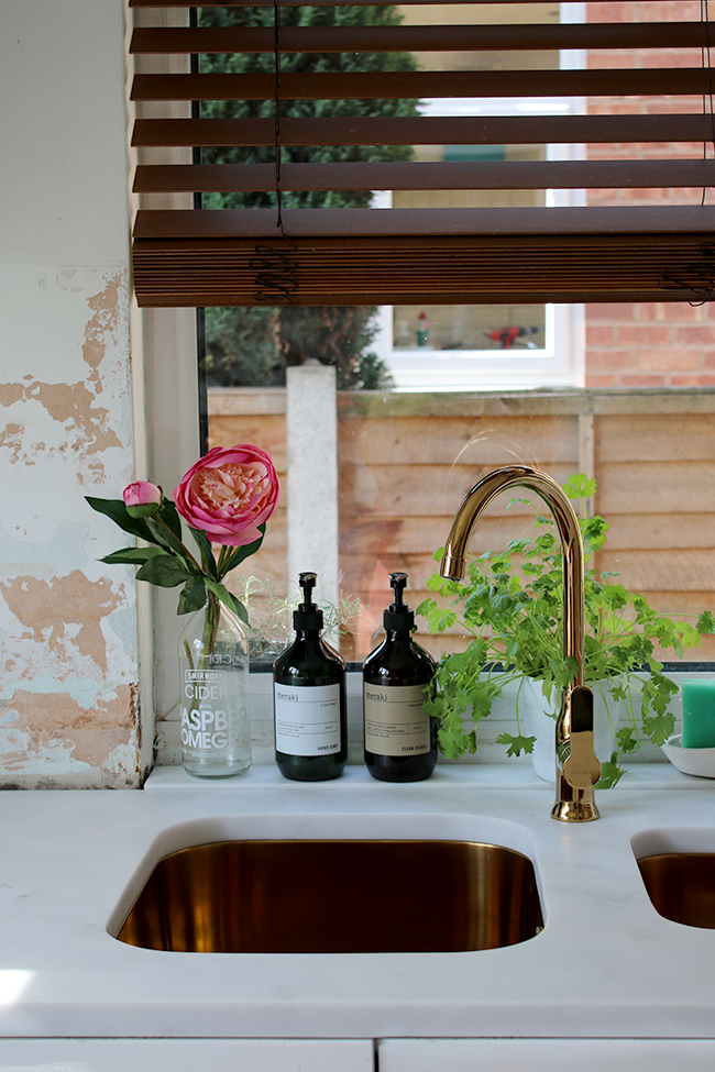 gold sink and tap in white kitchen