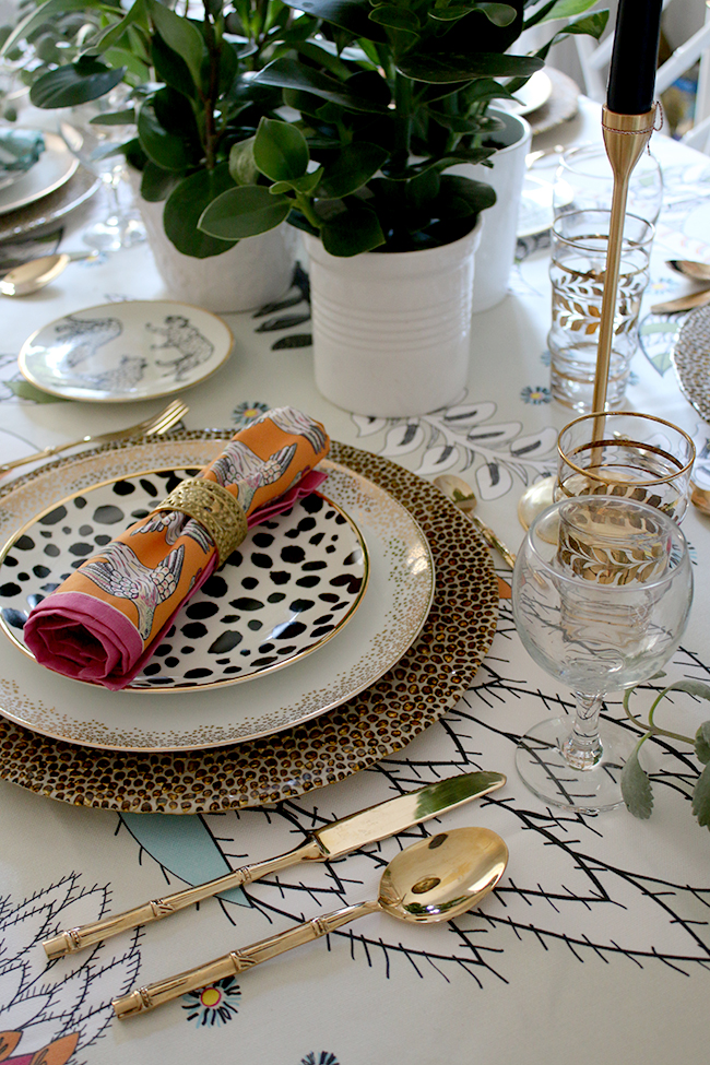 Colourful boho glam table setting with plants and animal prints