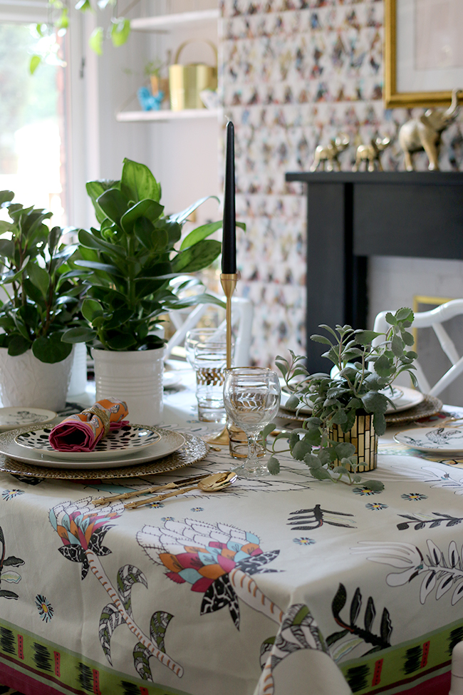 Colourful boho glam table setting with plants and animal prints