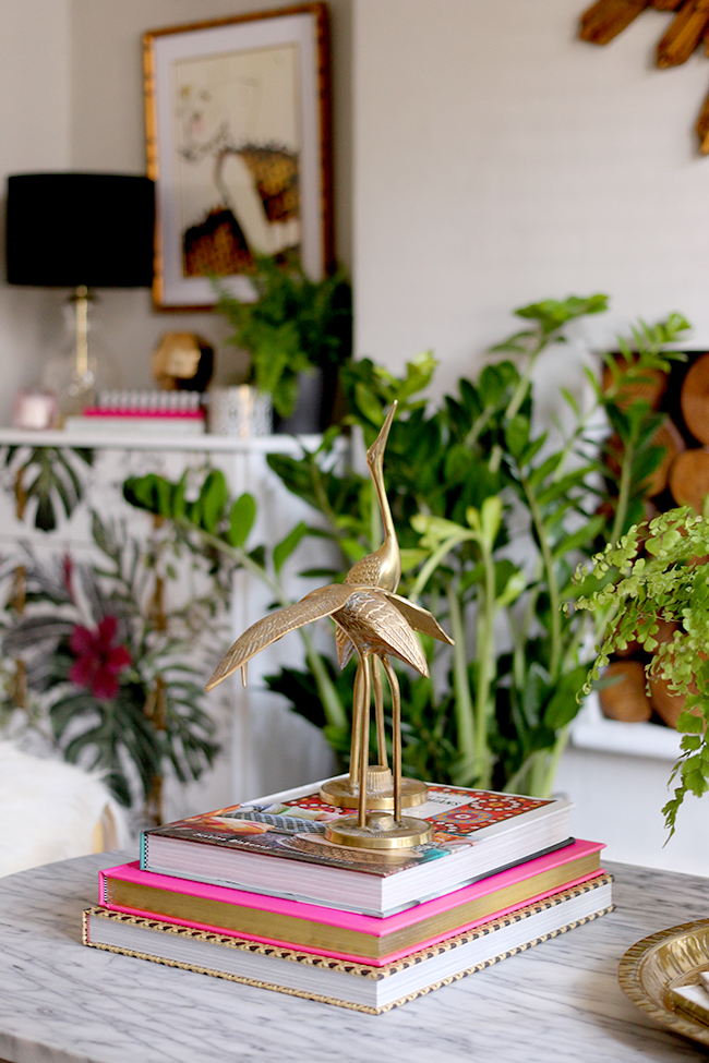 Living room with brass cranes and tropical prints