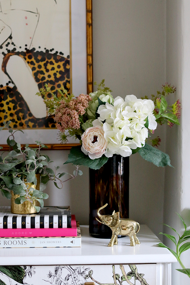 living room vignette with plants and flowers