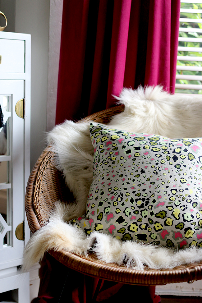 Simple updates that cost very little - leopard print cushion with goats hair throw on rattan chair