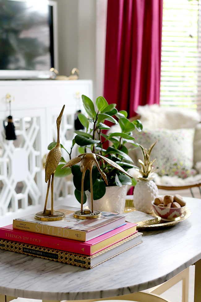 marble coffee table styling vignette with brass cranes