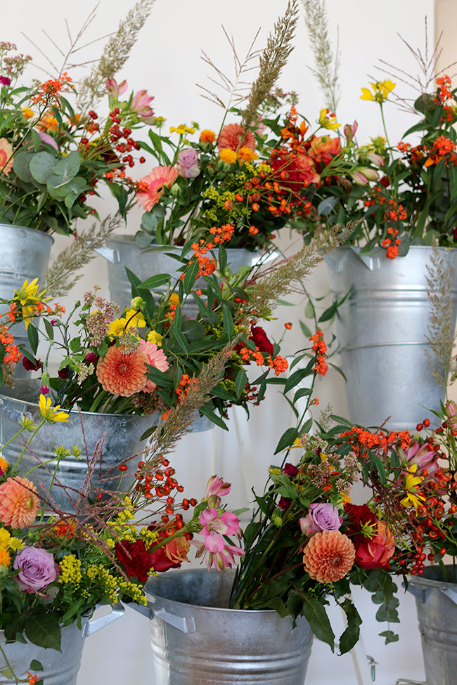 flowers in silver pots on display