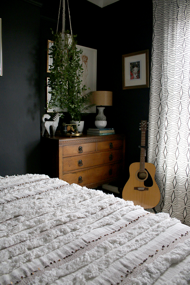 vintage chest of drawers with plants and moroccan throw bedroom