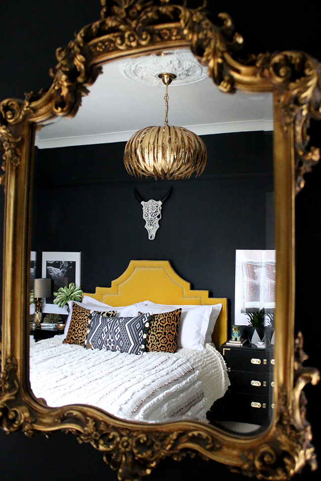 mirror reflection of eclectic boho glam bedroom in neutrals