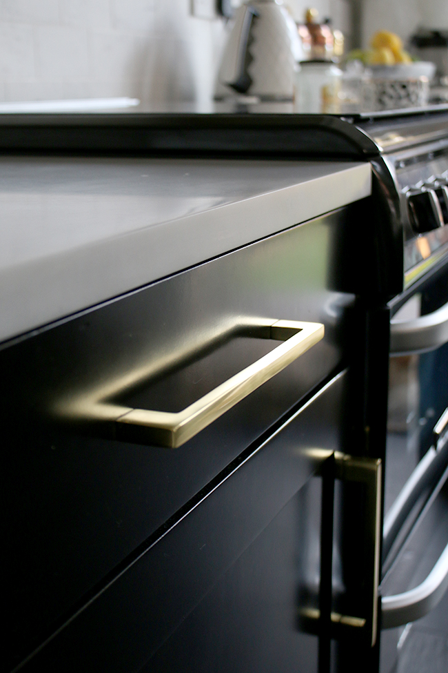 black kitchen cupboards with gold hardware