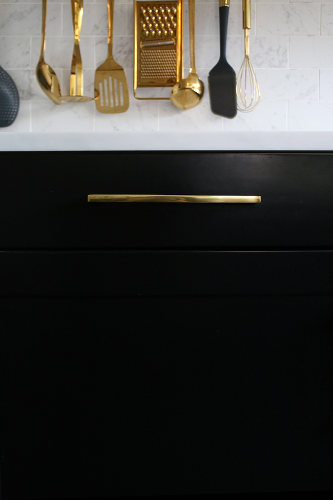 black kitchen cupboards with gold hardware