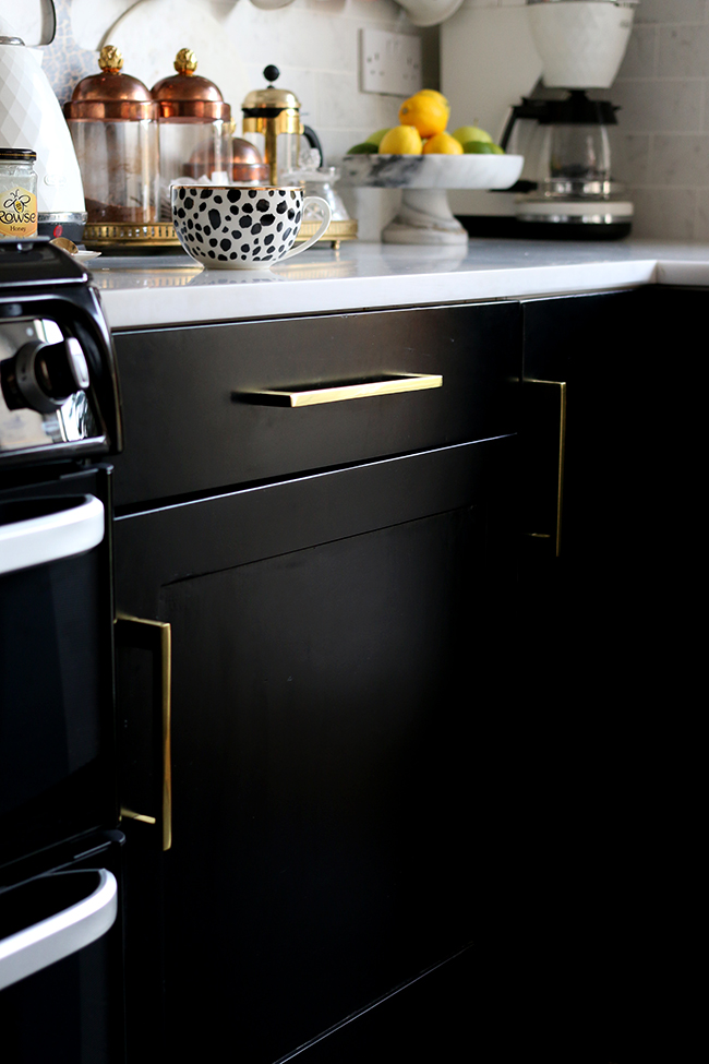 black kitchen cupboards with gold hardware