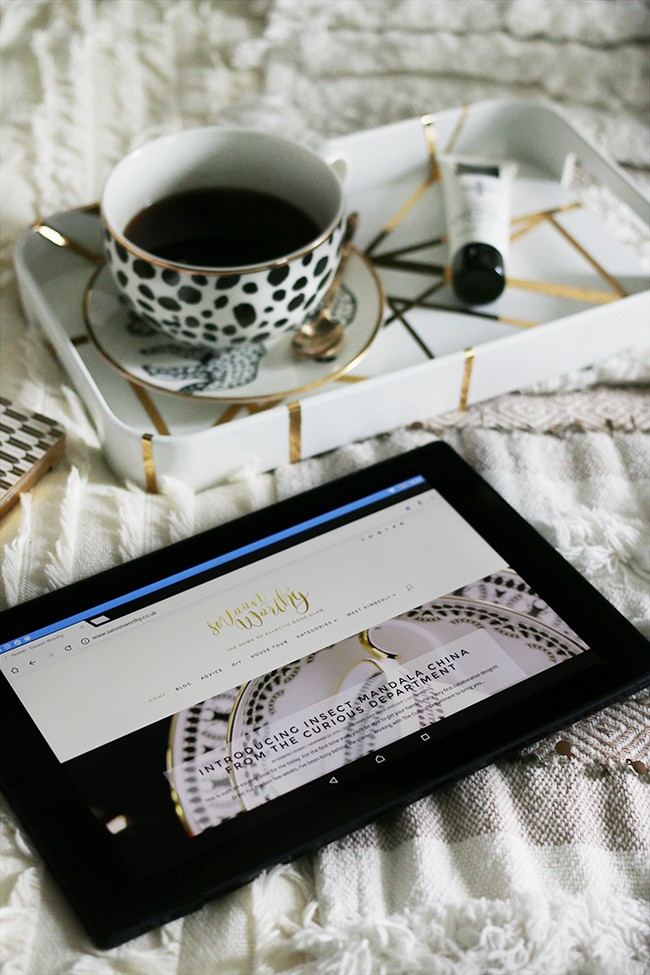 flatlay with tablet on bed with cup of coffee and leopard print neutrals texture