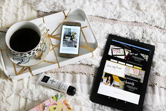 flatlay with tablet and mobile on bed with cup of coffee and leopard print neutrals texture