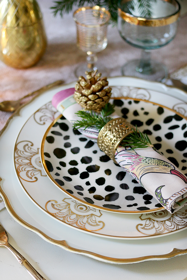 How to create a glam Christmas table setting on a budget with layered plates in gold black and white