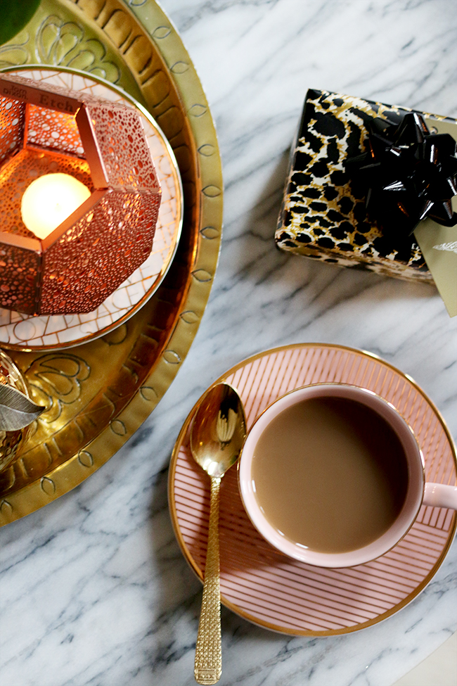 pink cup with coffee shot from above with christmas present and copper candle