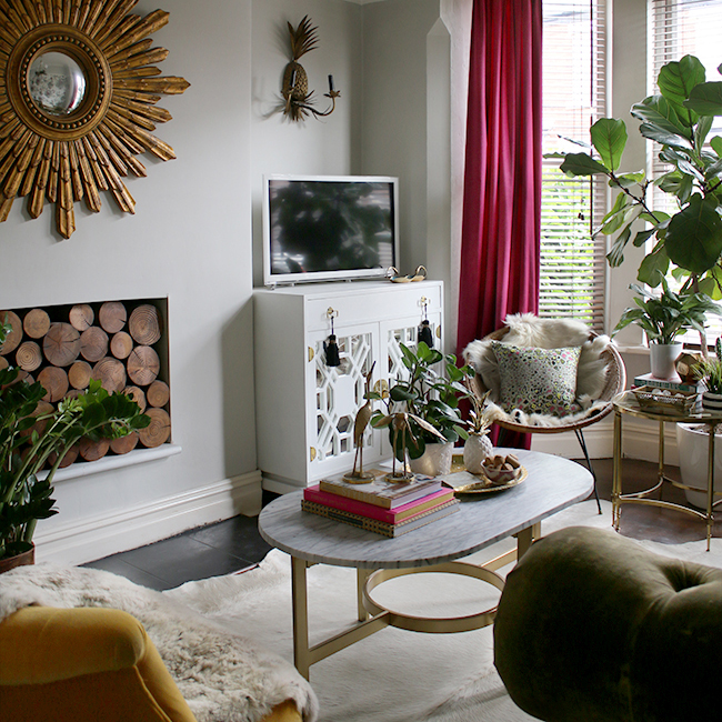 swoon worthy living room with vintage painted cabinet and sunburst mirror