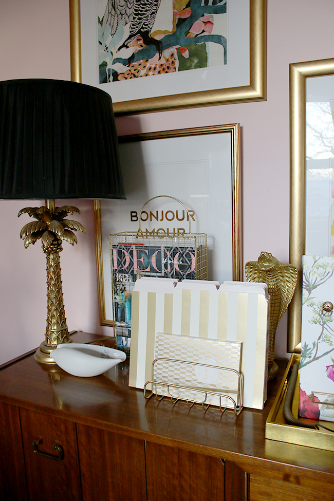 Gold office accessories in a blush pink office