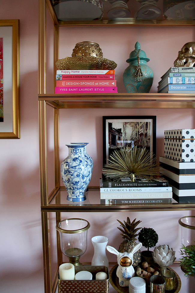 Pierre Vandel gold shelving unit in blush pink office