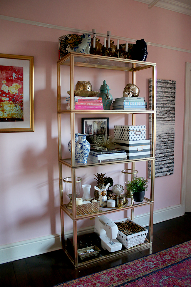 Pierre Vandel gold shelving unit in blush pink office