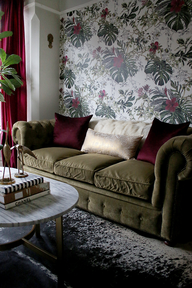 eclectic boho glam in deep claret and olive green chesterfield and tropical wallpaper