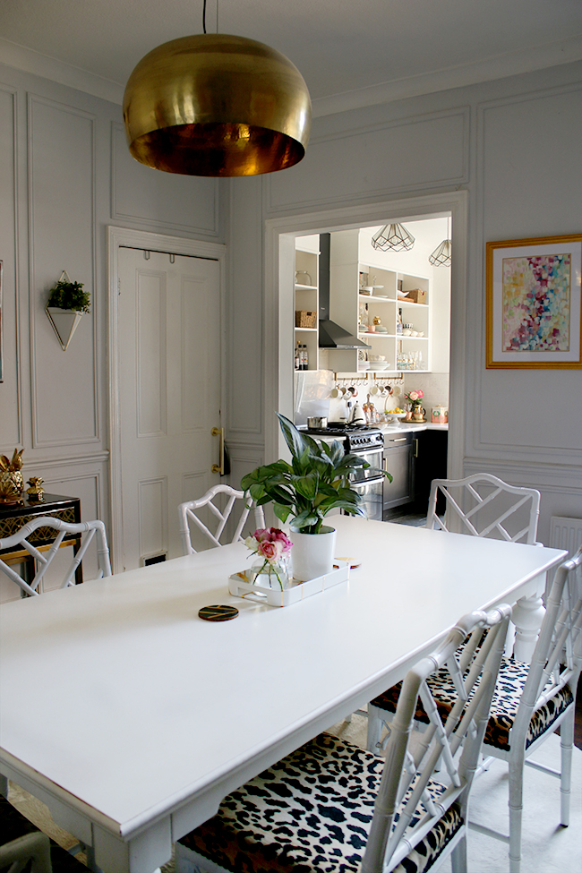 dining room with white cowhide and leopard print chairs