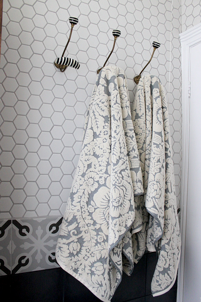 high quality towels on white hex tile background and anthropologie hooks