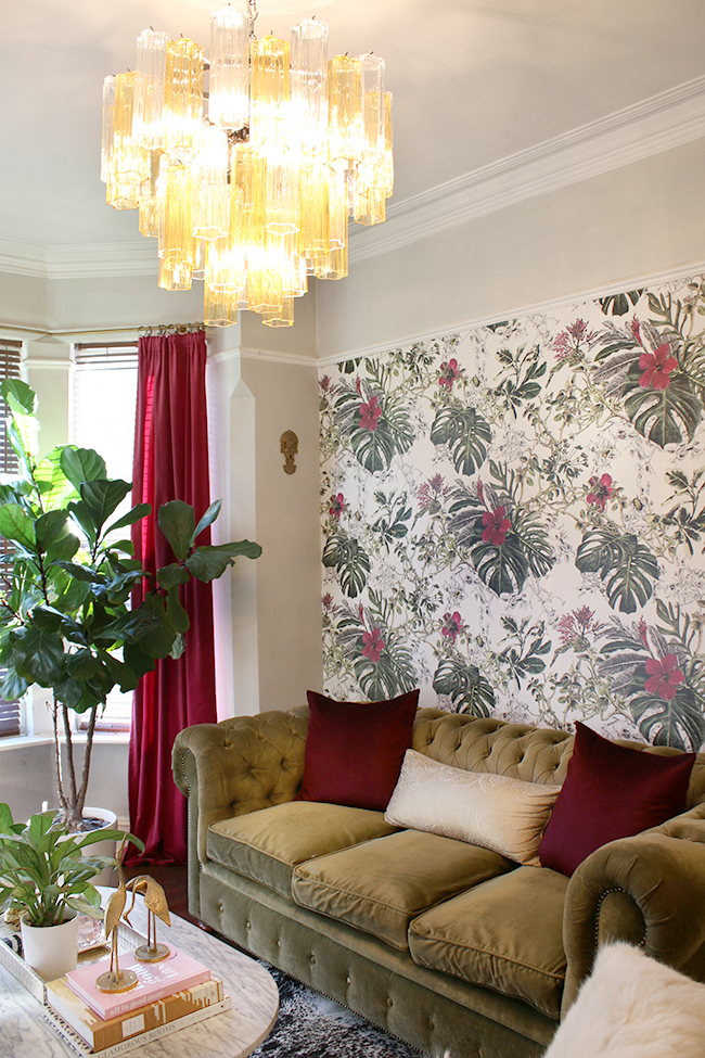 eclectic boho glam living room with tropical wallpaper and murano glass chandelier